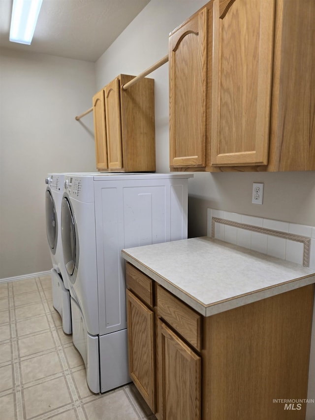 1203 Tara Ct, Fruitland, ID 83619 - laundry room featuring light floors, baseboards, cabinet space, and washing machine and clothes dryer