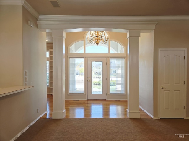 1203 Tara Ct, Fruitland, ID 83619 - entrance foyer with crown molding, an inviting chandelier, decorative columns, baseboards, and carpet