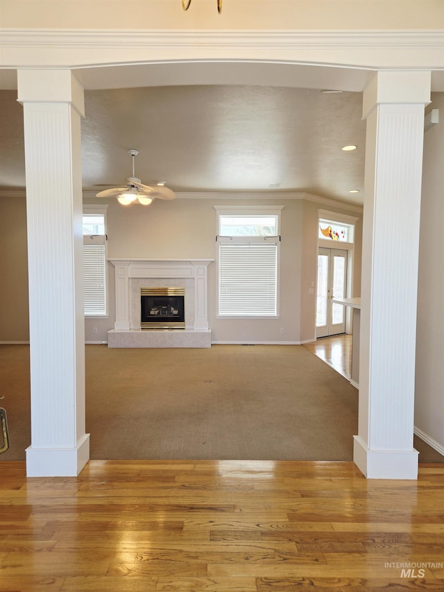 1203 Tara Ct, Fruitland, ID 83619 - unfurnished living room featuring ornate columns, ceiling fan, and baseboards