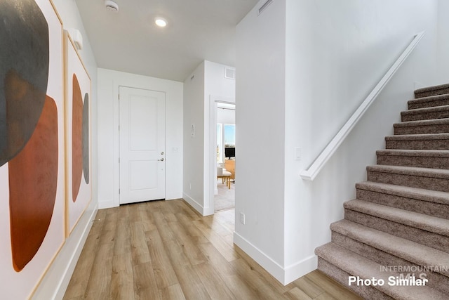 hallway with light hardwood / wood-style flooring