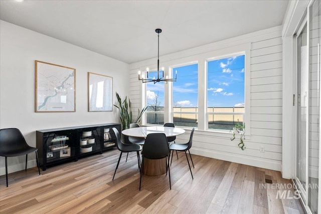 dining room featuring a notable chandelier and hardwood / wood-style flooring