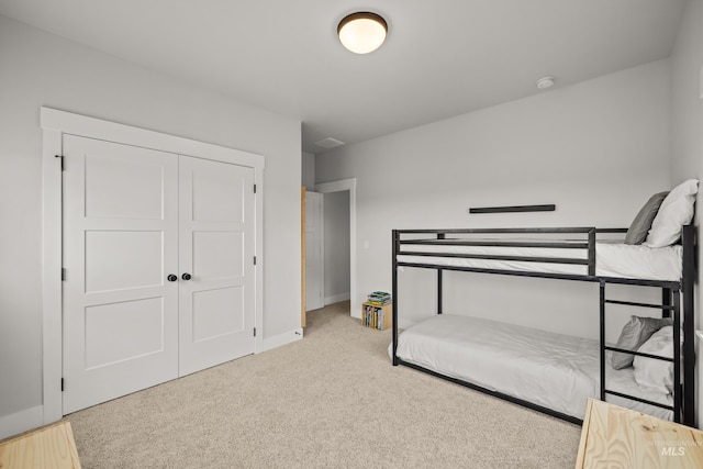 carpeted bedroom with a closet