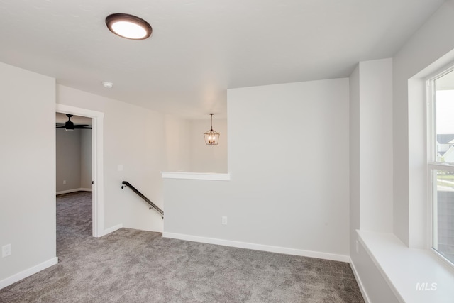 empty room featuring ceiling fan, a healthy amount of sunlight, and carpet flooring