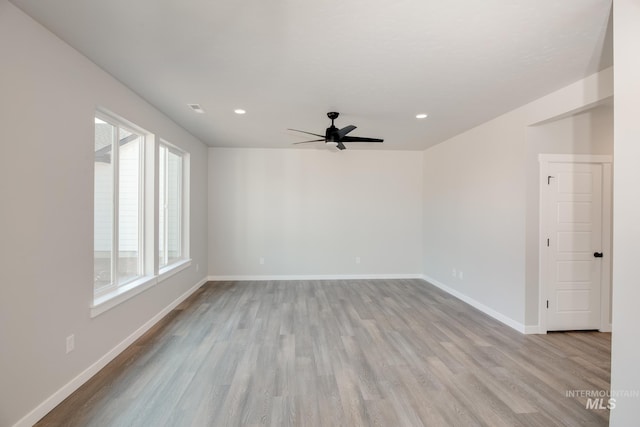 spare room featuring ceiling fan, light hardwood / wood-style flooring, and plenty of natural light