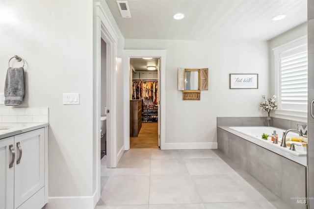 9115 S Palena Ave, Kuna, ID 83634 - full bath with a garden tub, vanity, tile patterned floors, a spacious closet, and baseboards