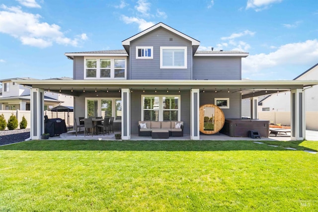 9115 S Palena Ave, Kuna, ID 83634 - back of house featuring a hot tub, a patio, and an outdoor hangout area