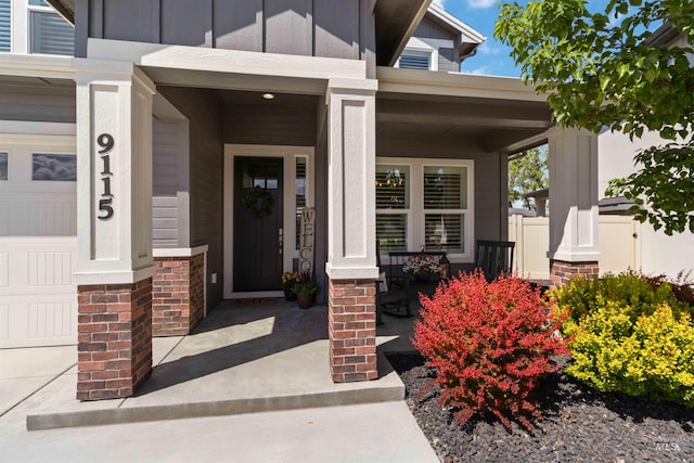 9115 S Palena Ave, Kuna, ID 83634 - doorway to property featuring a porch, board and batten siding, and a garage