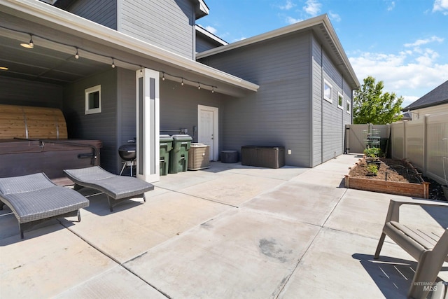 9115 S Palena Ave, Kuna, ID 83634 - view of patio / terrace with a hot tub and a garden