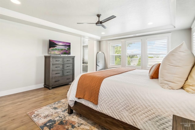 9115 S Palena Ave, Kuna, ID 83634 - bedroom with wood finished floors, baseboards, a tray ceiling, recessed lighting, and ceiling fan