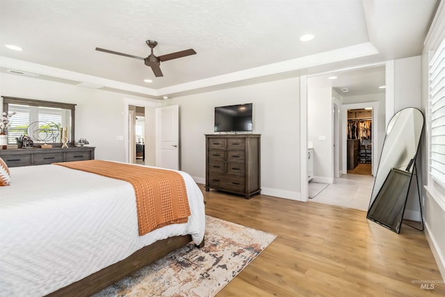 9115 S Palena Ave, Kuna, ID 83634 - bedroom with a raised ceiling, a spacious closet, baseboards, light wood-style flooring, and recessed lighting