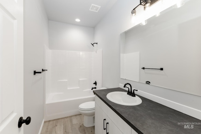 full bath featuring visible vents, toilet, vanity, wood finished floors, and  shower combination