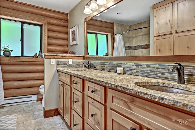 10 Daggett Rim, Boise, ID 83716 - bathroom featuring rustic walls, a baseboard radiator, tasteful backsplash, double vanity, and baseboards
