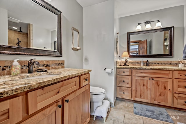 10 Daggett Rim, Boise, ID 83716 - bathroom featuring toilet, two vanities, and backsplash
