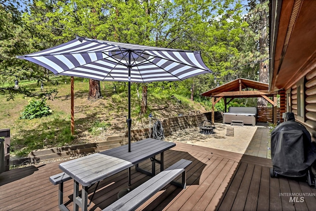 10 Daggett Rim, Boise, ID 83716 - wooden deck with outdoor dining area, a hot tub, a fire pit, and area for grilling