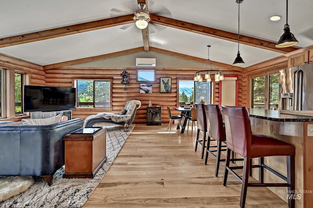 10 Daggett Rim, Boise, ID 83716 - living room featuring a wall mounted AC, rustic walls, light wood finished floors, and healthy amount of natural light