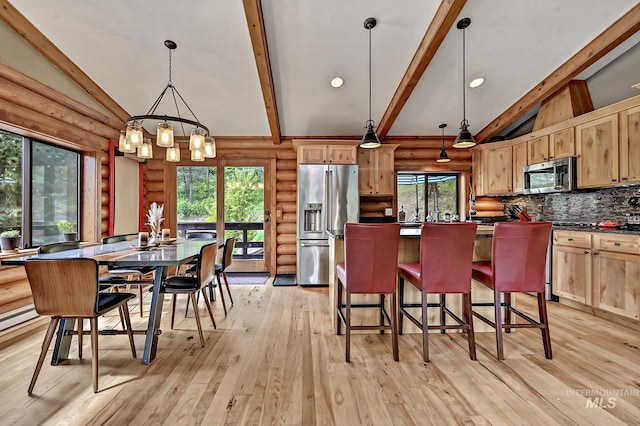 10 Daggett Rim, Boise, ID 83716 - kitchen featuring stainless steel appliances, dark countertops, beam ceiling, rustic walls, and decorative backsplash