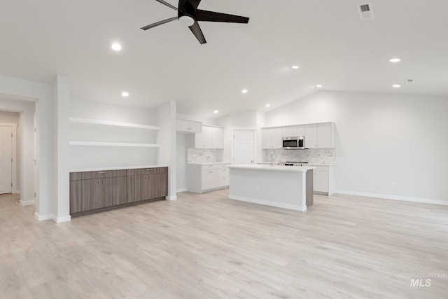 unfurnished living room with a ceiling fan, lofted ceiling, light wood-style flooring, recessed lighting, and baseboards