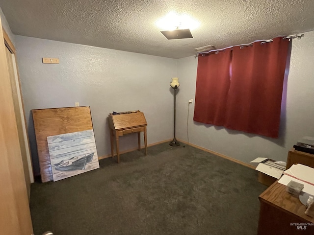 misc room featuring carpet flooring, baseboards, and a textured ceiling