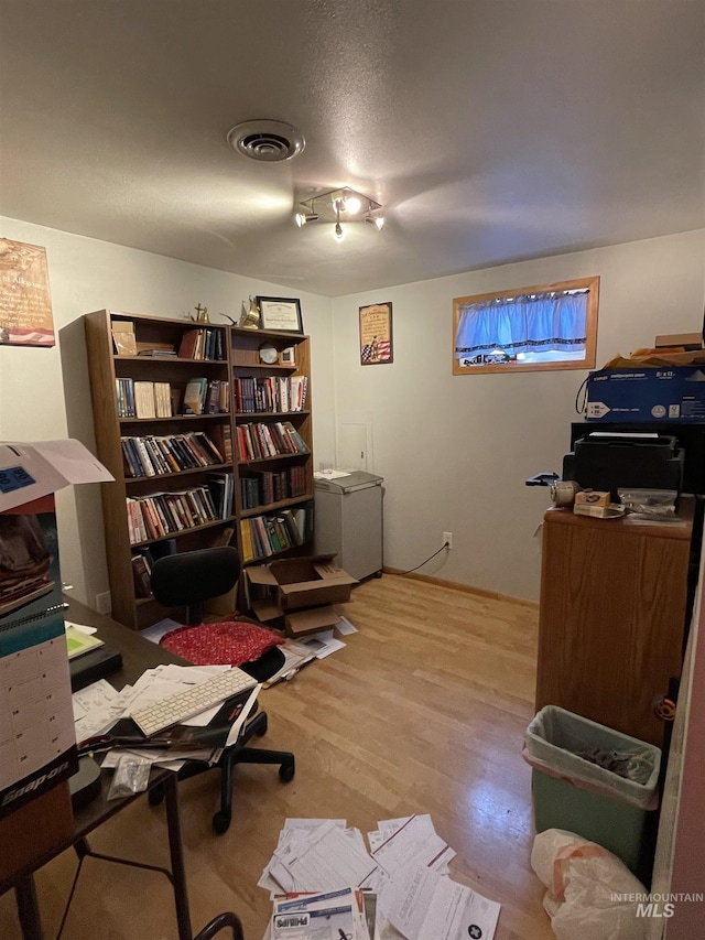 home office with wood finished floors and visible vents