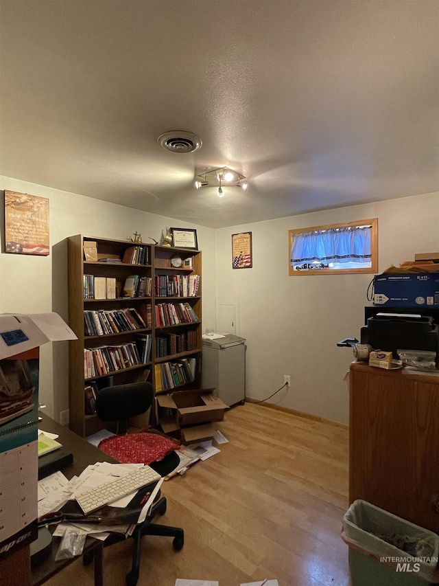 office area with visible vents and wood finished floors