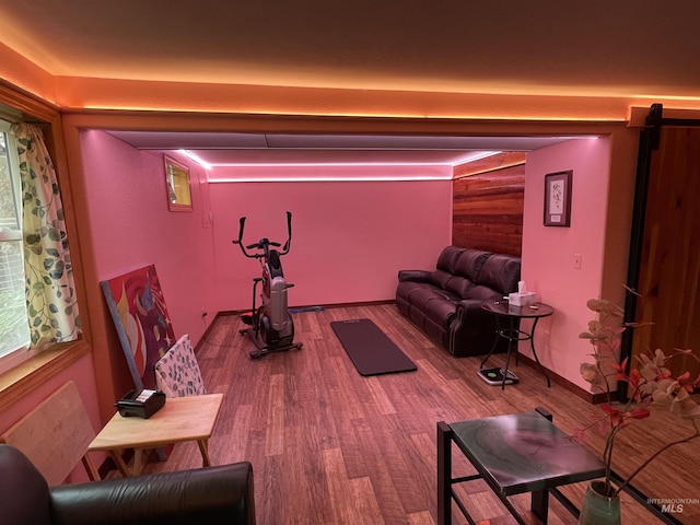 workout room with baseboards and wood finished floors