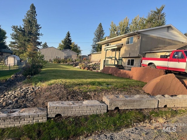 view of property exterior with a yard and fence