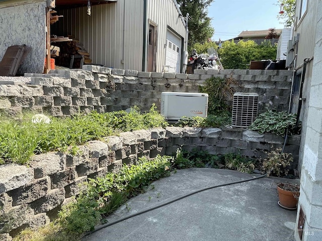 view of patio / terrace with cooling unit, a garage, and fence