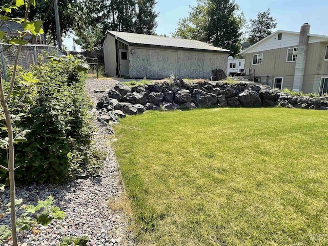 view of yard featuring an outbuilding and fence