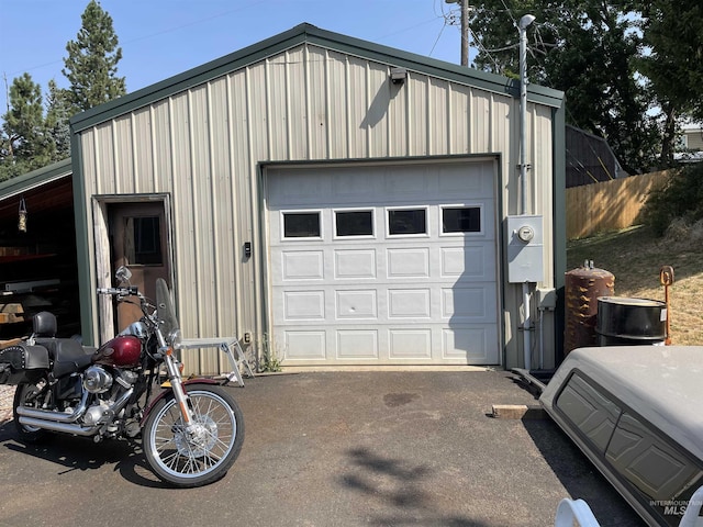 detached garage with fence and driveway