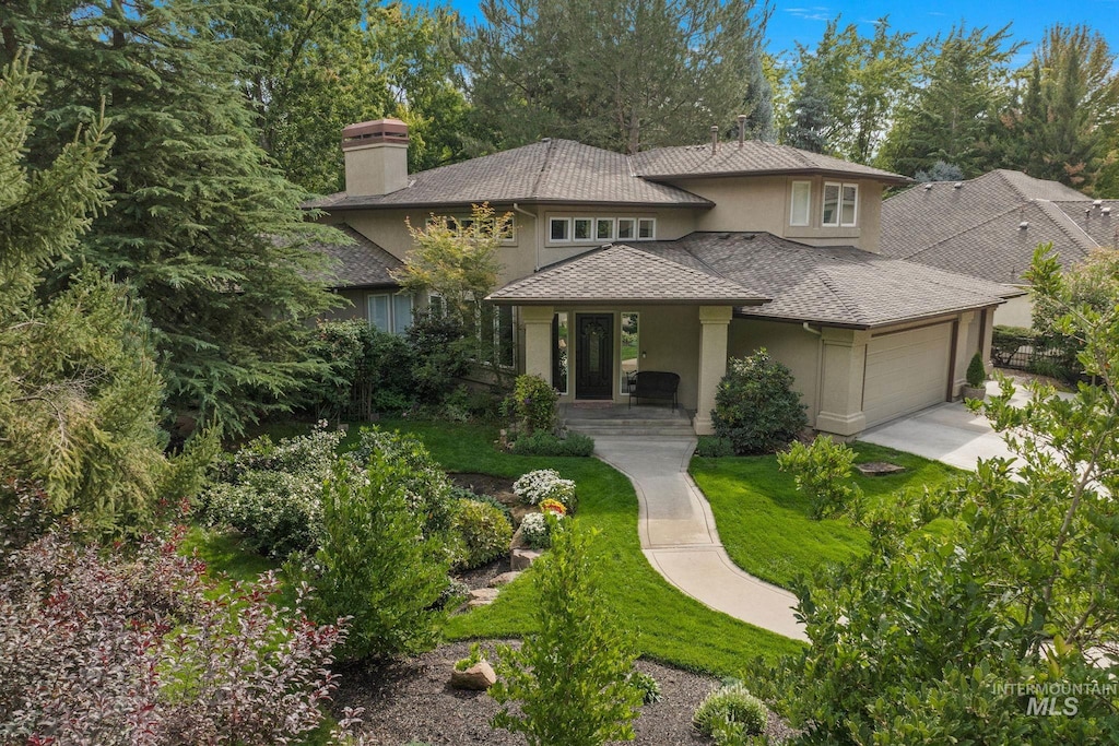 prairie-style home with a garage and a front yard