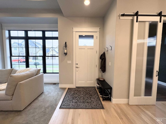 entrance foyer featuring a barn door and hardwood / wood-style flooring