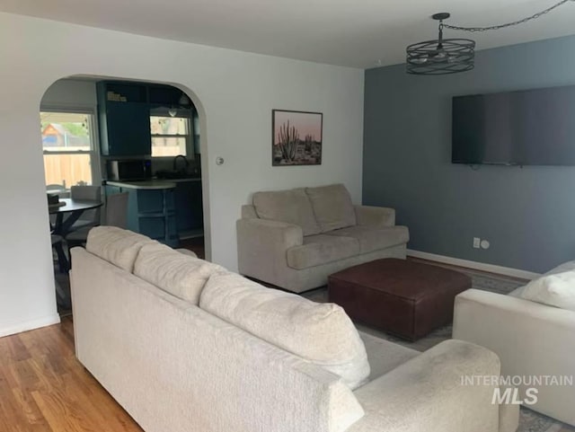 living room featuring hardwood / wood-style floors and a notable chandelier