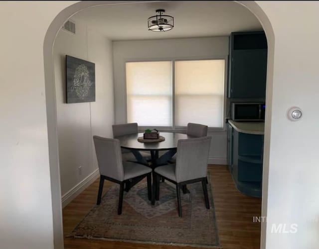 dining area featuring dark hardwood / wood-style floors