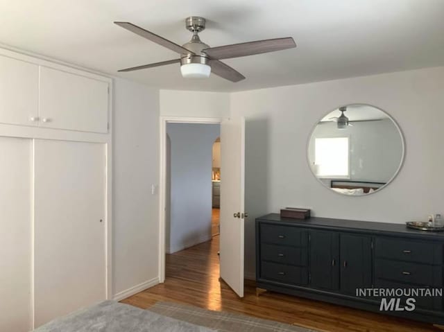 bedroom with ceiling fan and dark wood-type flooring