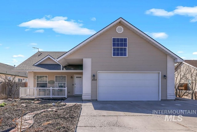 1003 Lauren Ln, Filer, ID 83328 - traditional-style home featuring fence, roof with shingles, an attached garage, covered porch, and concrete driveway