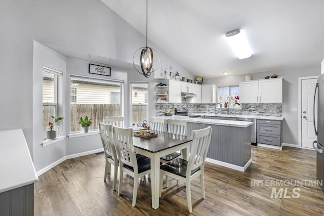 1003 Lauren Ln, Filer, ID 83328 - dining room featuring a chandelier, dark wood-type flooring, and baseboards