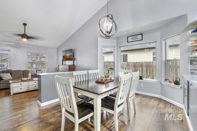 1003 Lauren Ln, Filer, ID 83328 - dining room featuring ceiling fan with notable chandelier, high vaulted ceiling, baseboards, and wood finished floors