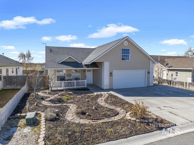 1003 Lauren Ln, Filer, ID 83328 - traditional-style home featuring concrete driveway, a garage, fence, and covered porch