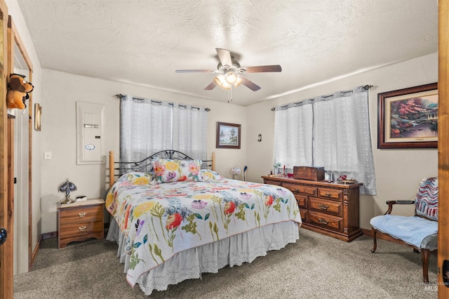 carpeted bedroom with baseboards and ceiling fan