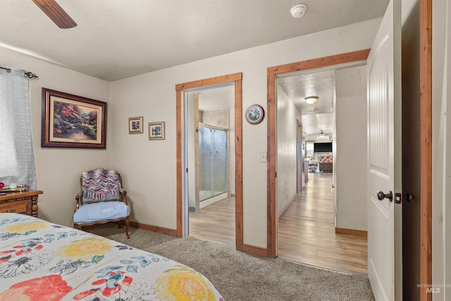 bedroom featuring baseboards and light colored carpet