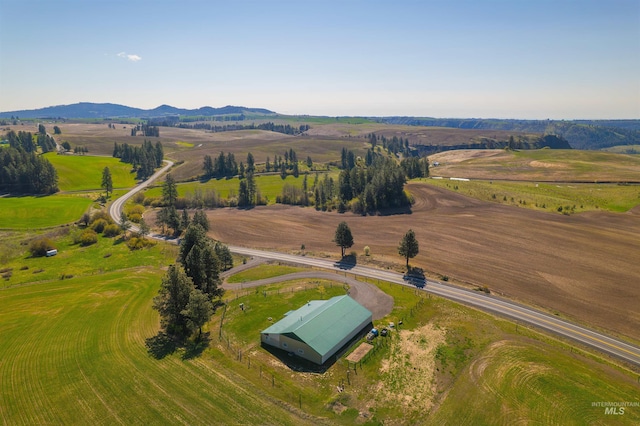 aerial view featuring a rural view and a mountain view