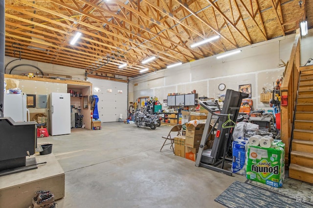 garage featuring freestanding refrigerator and electric panel