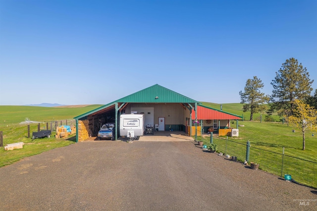 exterior space featuring a garage, fence, and driveway