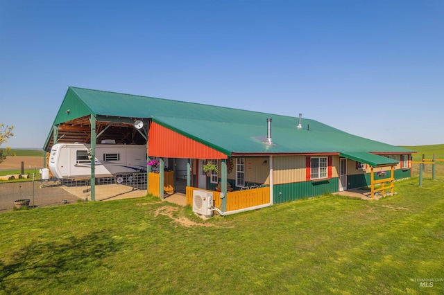 back of property featuring a carport, an exterior structure, ac unit, and metal roof