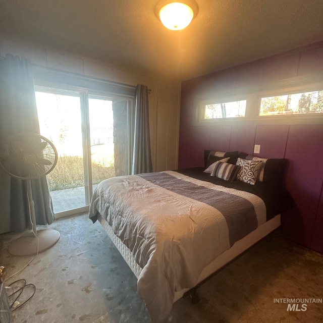 bedroom with access to outside and a textured ceiling