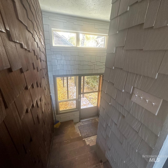 interior space with a textured ceiling, wood-type flooring, and a wealth of natural light