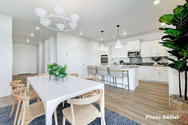 dining space with light hardwood / wood-style floors