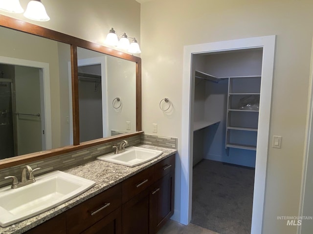 2504 E Hidden Creek St, Nampa, ID 83687 - full bathroom with double vanity, a spacious closet, and backsplash