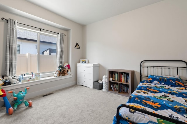 carpeted bedroom featuring baseboards