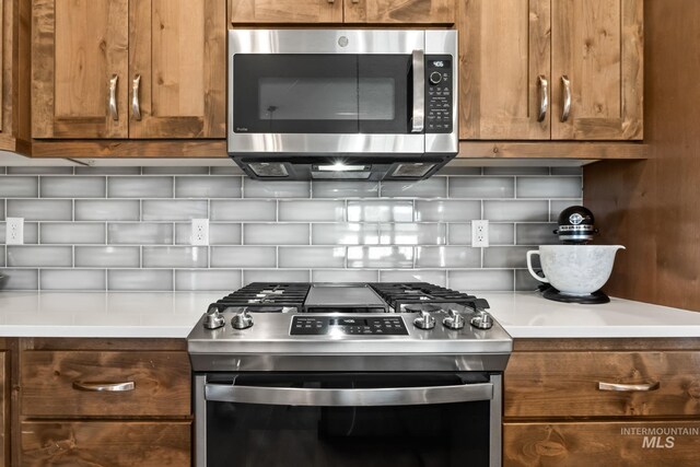 kitchen with stainless steel appliances, tasteful backsplash, and brown cabinetry